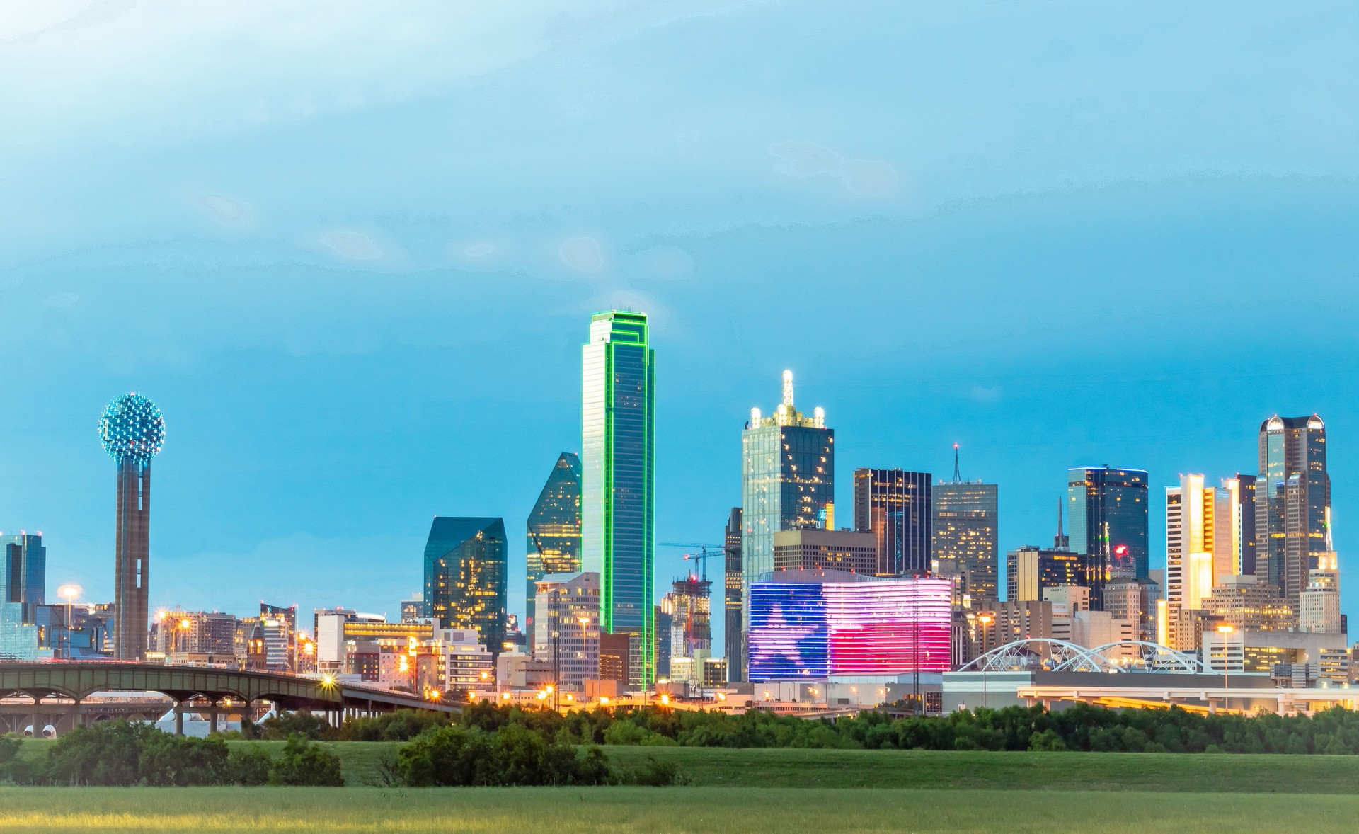 Illuminated colorful downtown Dallas Texas city skyline buildings. Photo taken in the evening at blue hour twilight Illuminated colorful downtown Dallas Texas city skyline buildings. Photo taken in the evening at blue hour twilight
